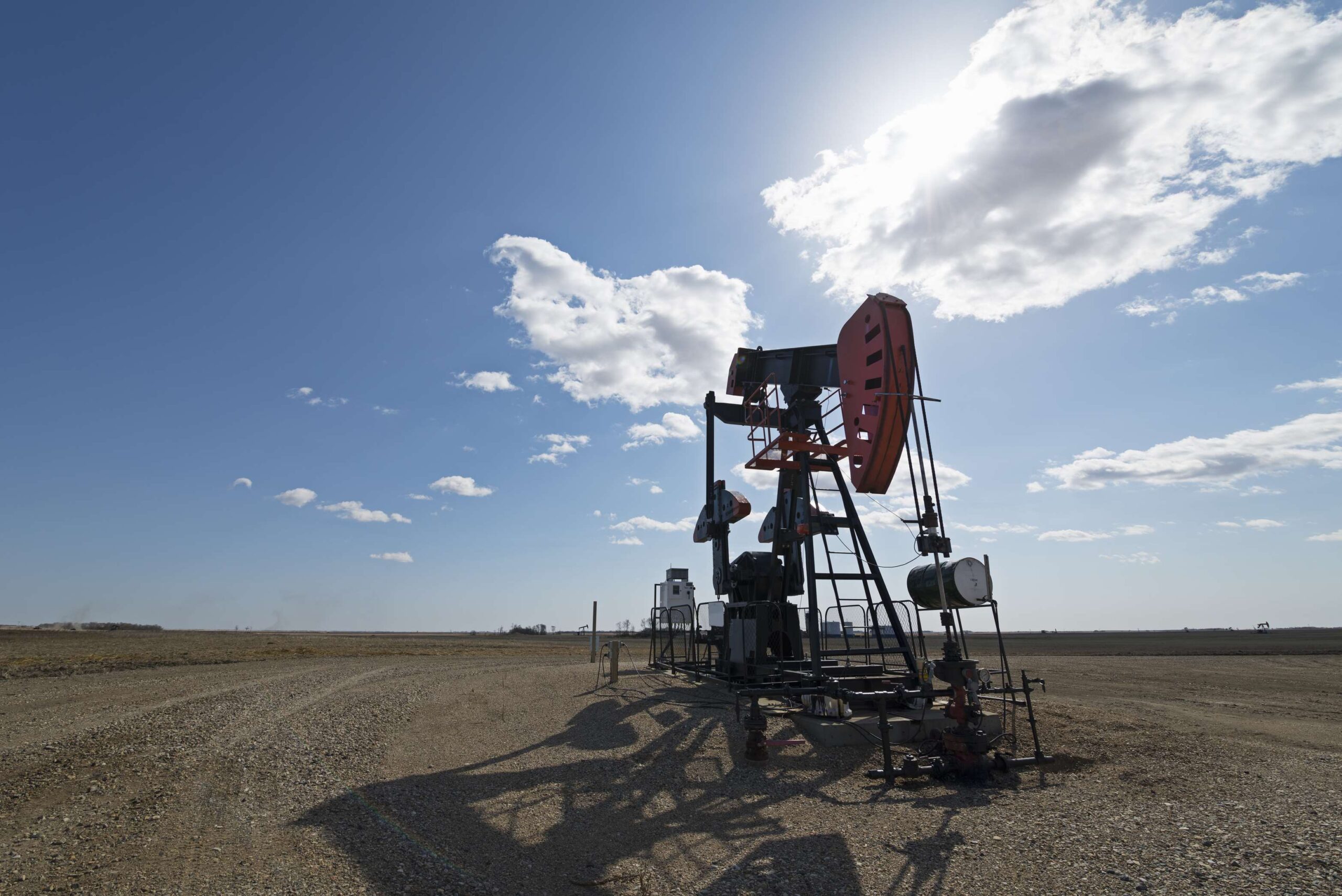 //bowsherps.com/wp-content/uploads/2023/03/a-pump-jack-in-open-ground-at-an-oil-extraction-si-2022-03-04-02-42-07-utc-scaled.jpg